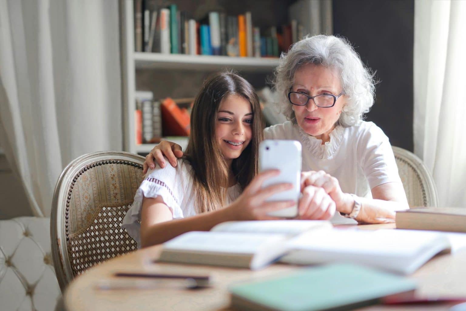 Grandparents and Grandchildren Forge Special Bond, Learning Together in the Modern Age Photo of Woman Showing Her Cellphone to Her Grandmother