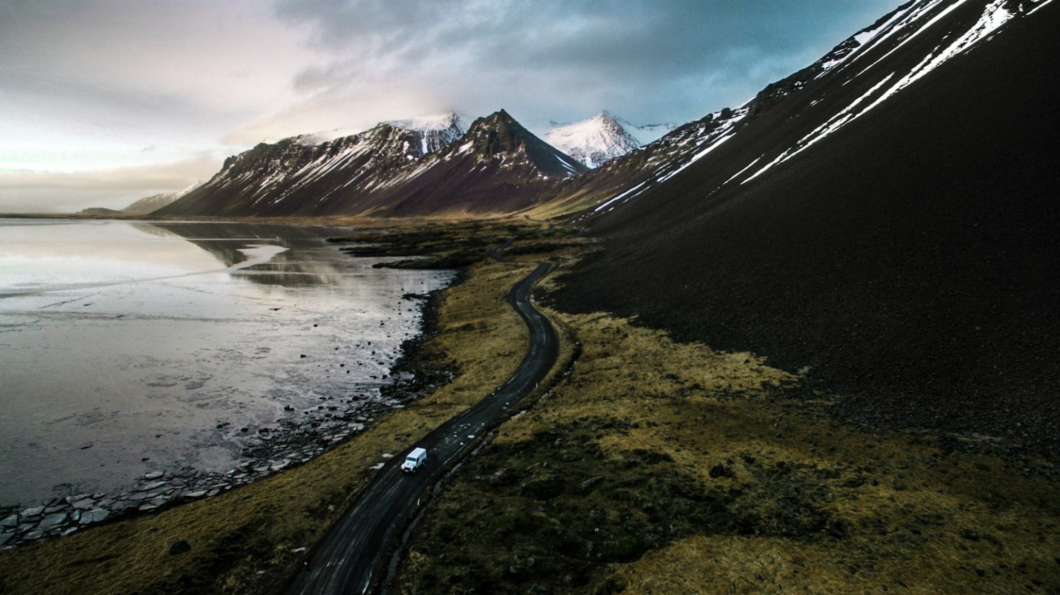 Iceland Reinstates Tourist Tax in 2024: A Green Initiative mountains near body of water
