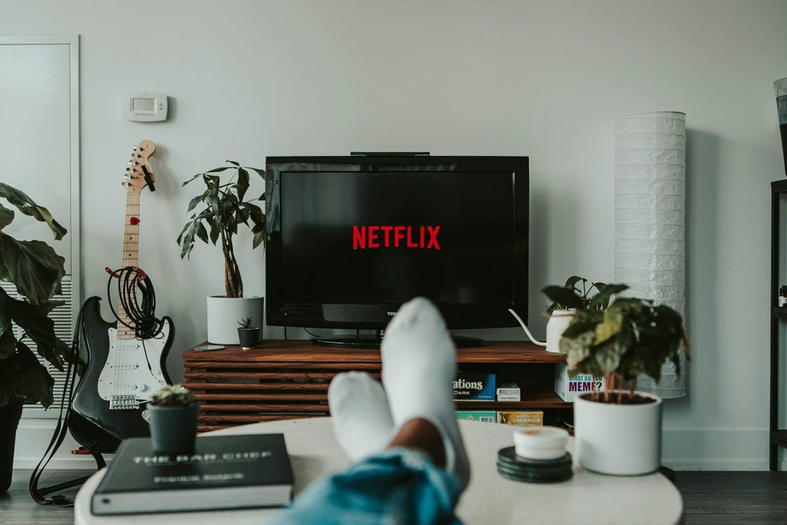 Netflix Gains 13 Million Subscribers Amid Password-Sharing Crackdown black flat screen tv turned on displaying 11