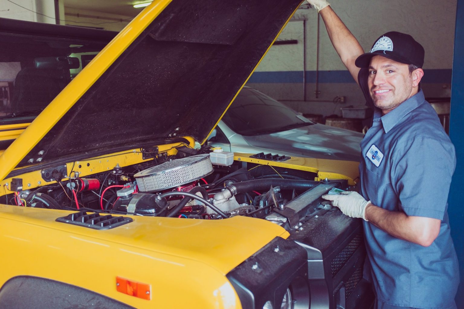 7 Expert Tips for Summer Car Maintenance man holding open-wide car trunk