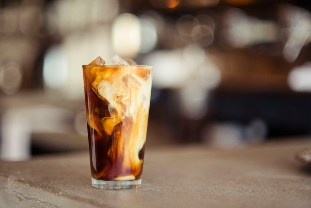6 Tips for Brewing Barista-Quality Coffee at Home glass cup filled with ice latte on tabletop