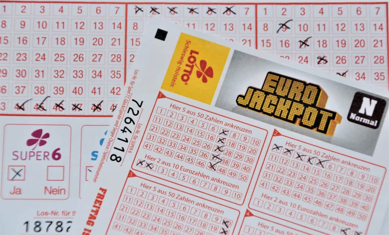 Revealed: UK Areas Most Likely to Win the Postcode Lottery white and red calendar on white wall