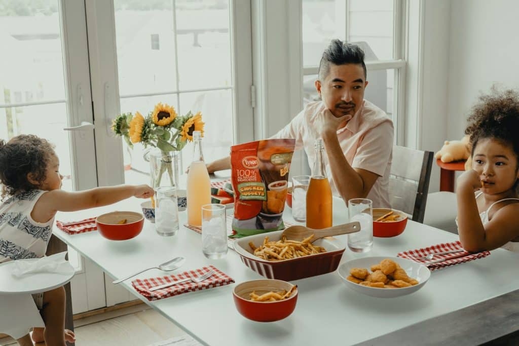Hungry Schoolchildren at Risk of Missing Out on Dream Careers woman in white crew neck t-shirt sitting on chair in front of table with foods