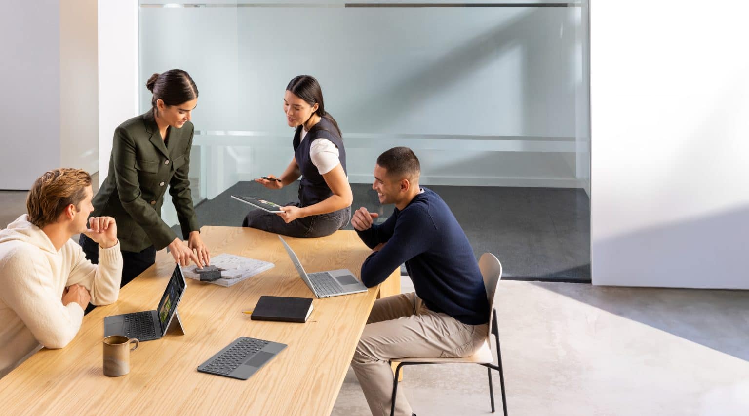 UK small business owner managing digital AI workflow on laptop in modern office.